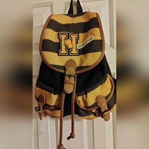 This Harry Potter Hufflepuff Varsity Backpack in black, tan, and gold is a must-